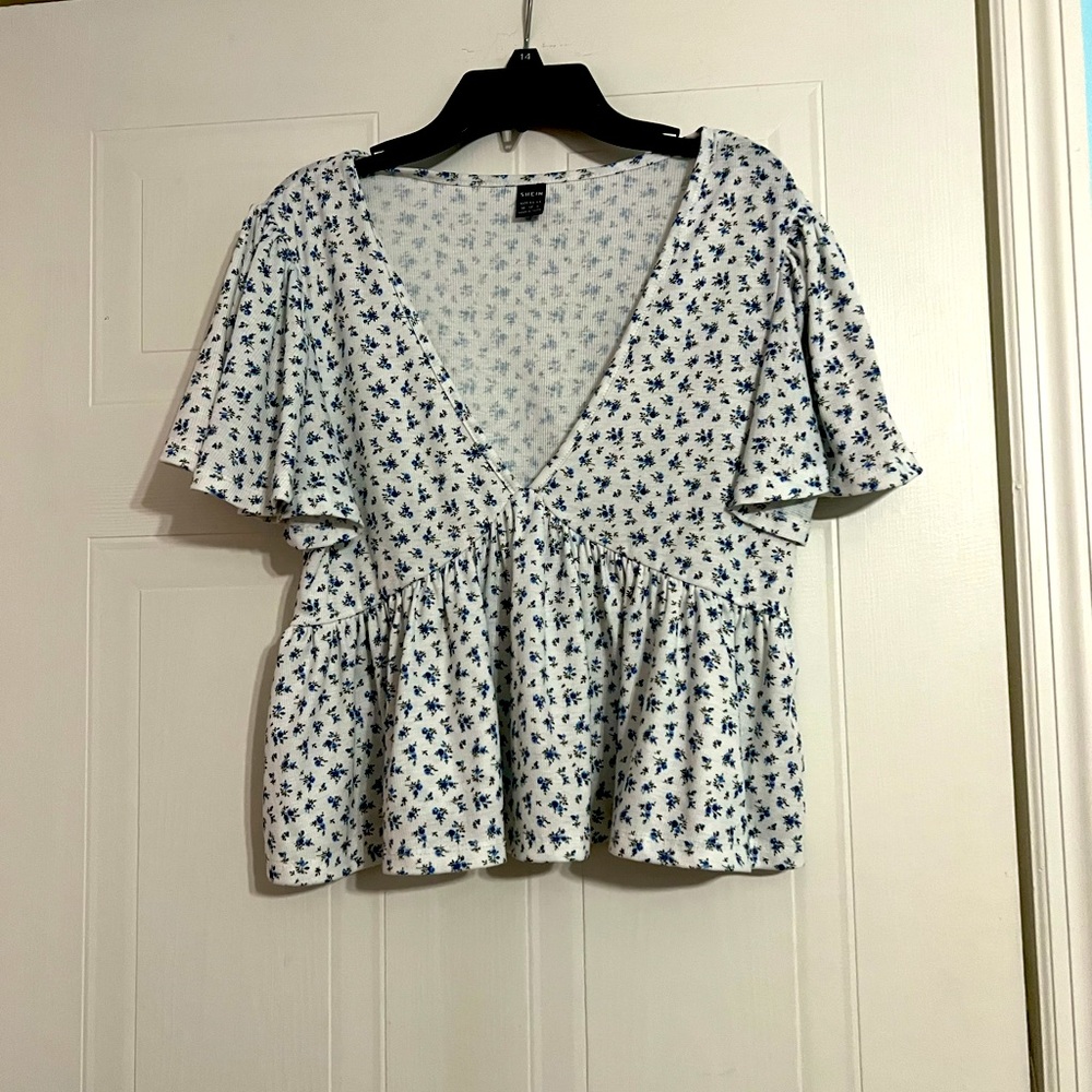 A cute, flowy, floral pattern, deep v-neck shirt